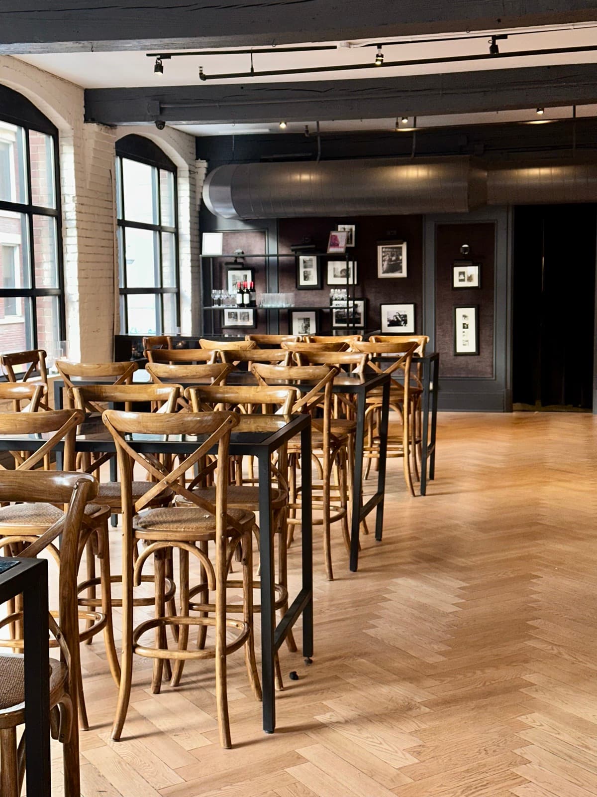 High-top tables and stools on the herringbone floor