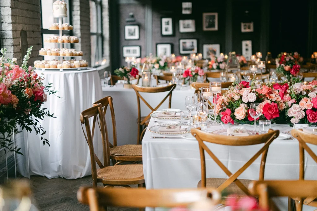 Spring wedding setup with pink florals and cupcake tower at Storys venue