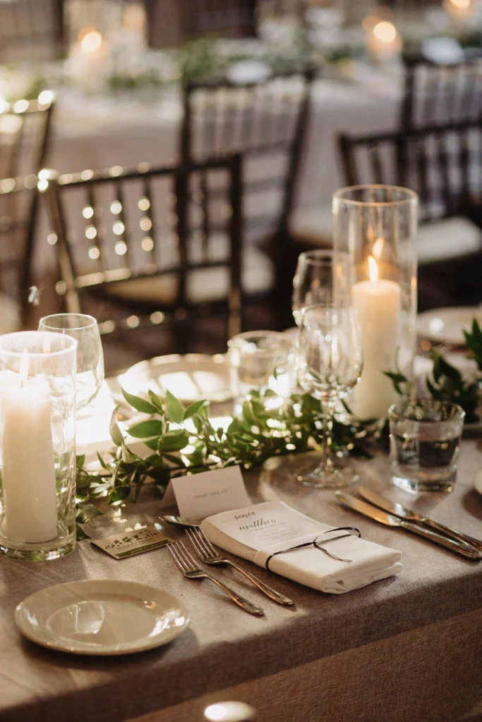 candlelit wedding table setup with personalized name cards and greenery at STORYS Toronto event venue.