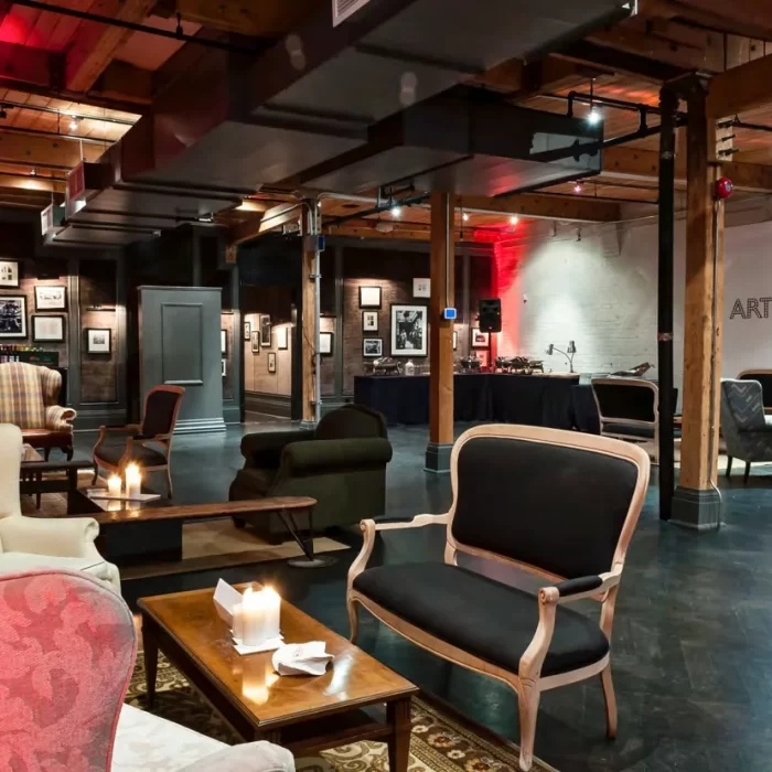 Chic urban lounge setup for corporate events, social gatherings, and film shoots with ambient lighting, vintage seating, and wall art décor.